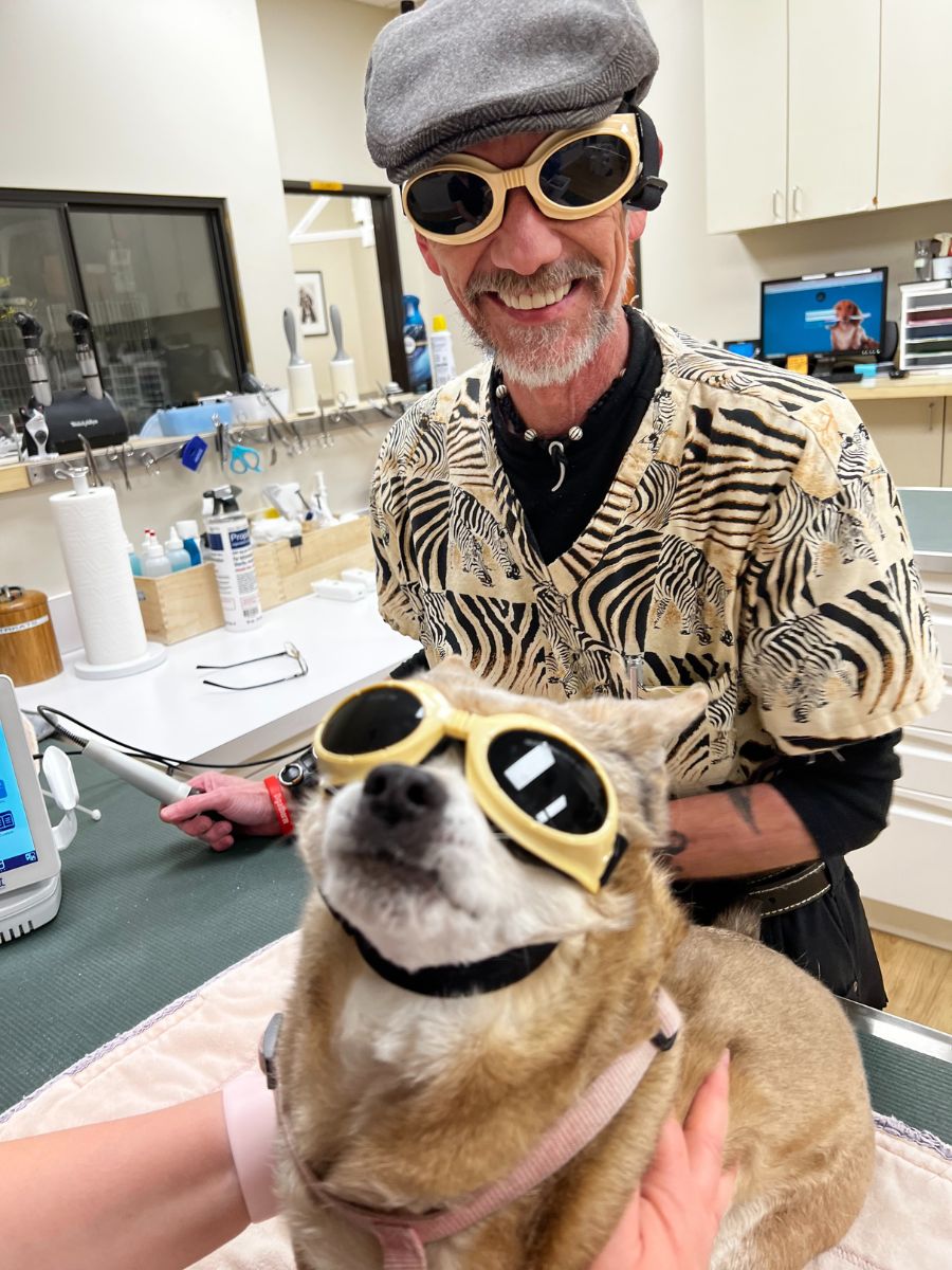 A man and a dog with sunglasses